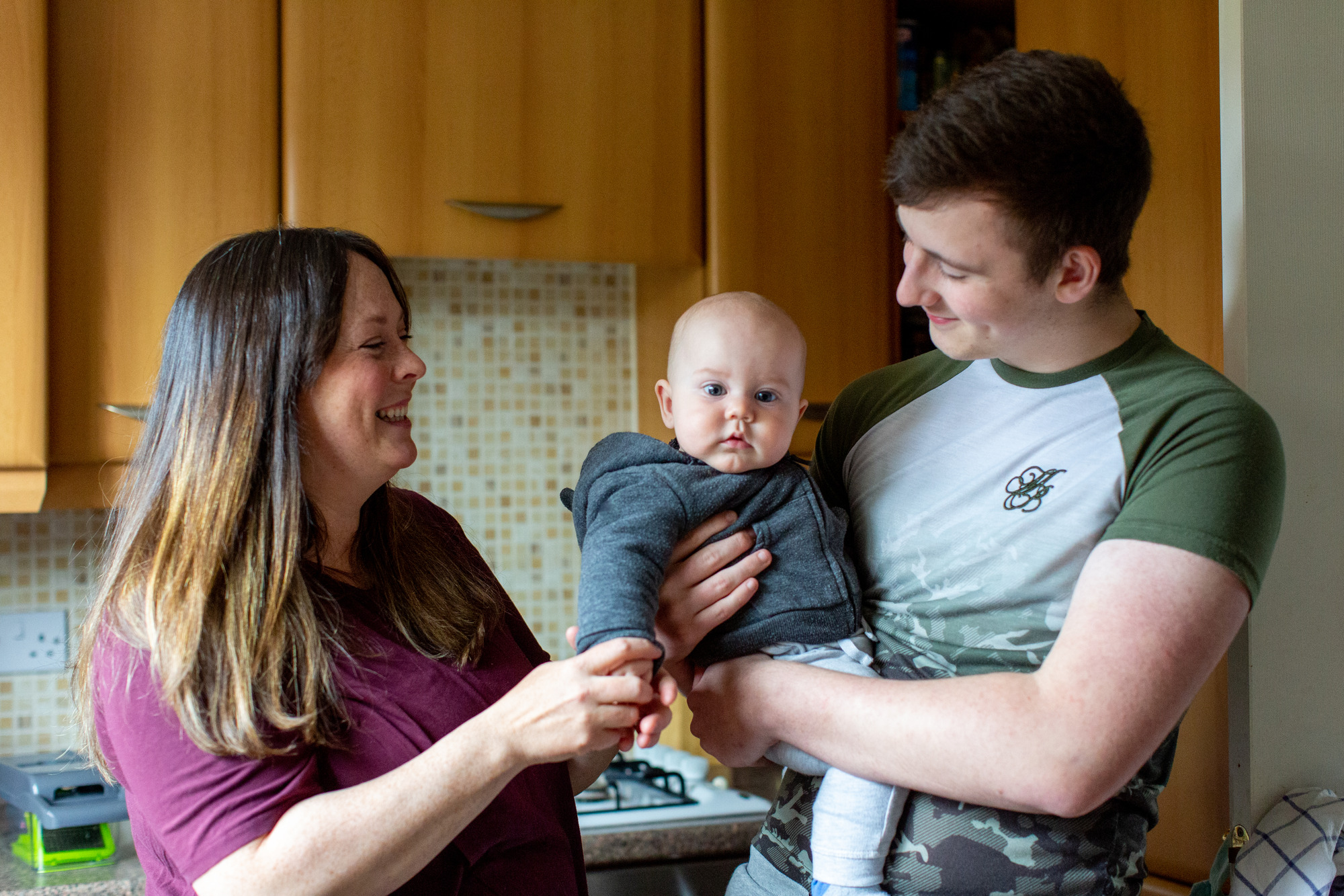 Man and woman with baby in kitchen